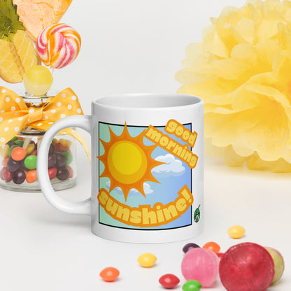 White Wizard Prints mug with 'Good morning sunshine' text and sunny graphic surrounded by colorful candies and flowers.