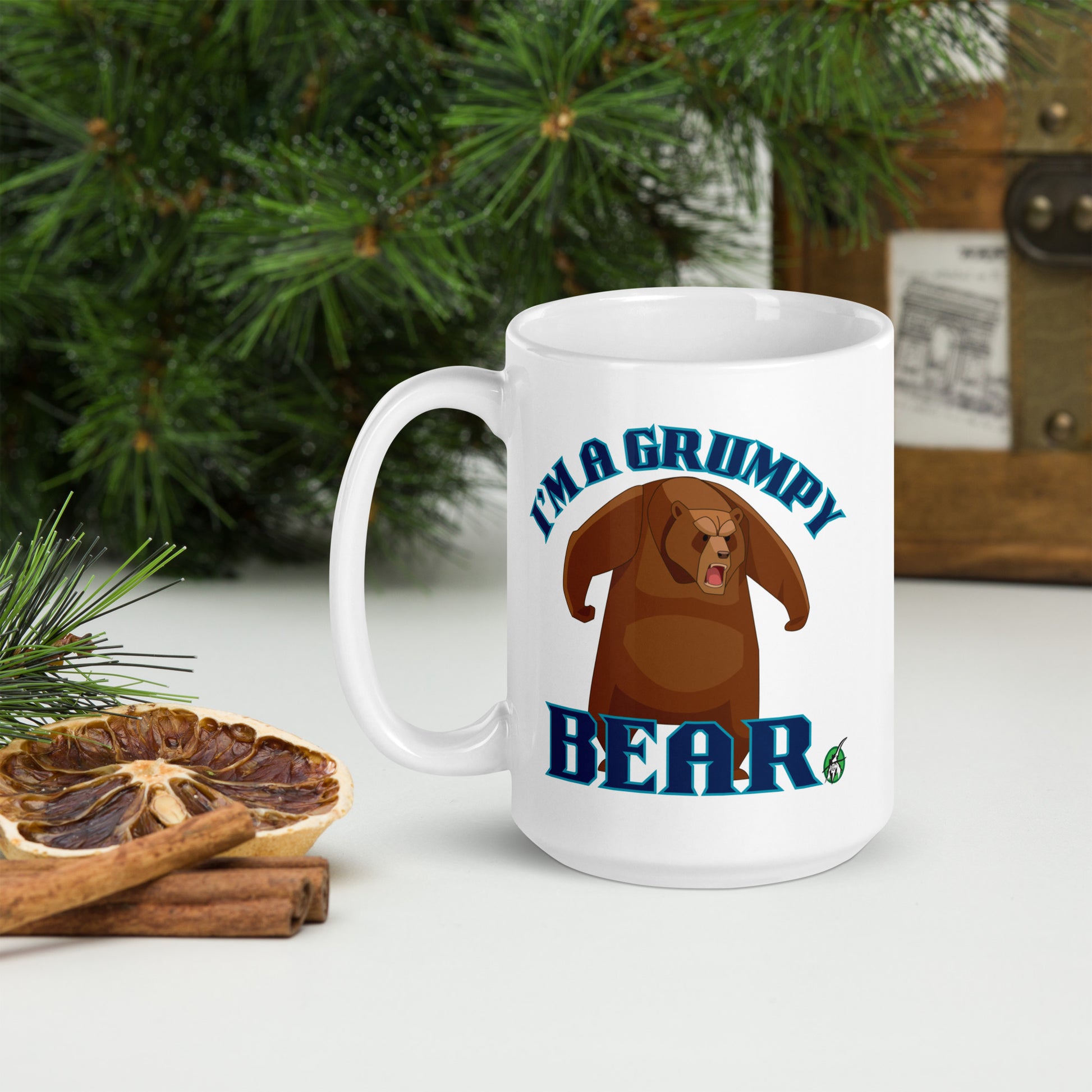 Wizard Prints white mug with grumpy bear graphic and 'I'm a grumpy bear' text on a surface with decorative nature elements.