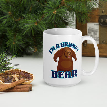 Wizard Prints white mug with grumpy bear graphic and 'I'm a grumpy bear' text on a surface with decorative nature elements.