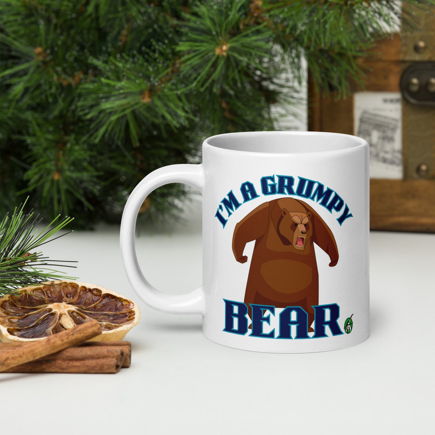 Wizard Prints white mug with grumpy bear graphic and 'I'm a grumpy bear' text on a surface with decorative nature elements.