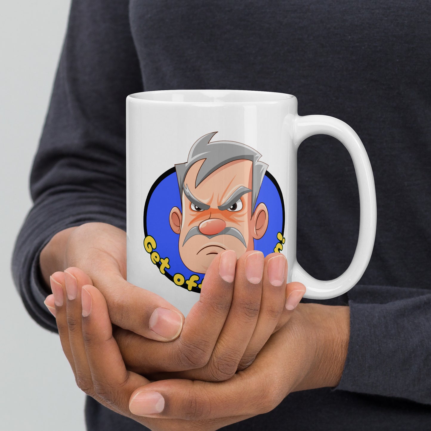 Person holding a white Wizard Prints grumpy old man mug with a cartoon old man graphic and 'Get off my lawn!' text.