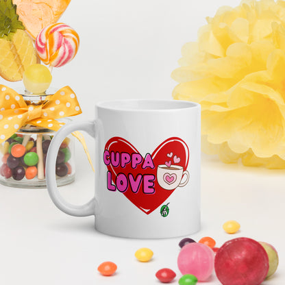 White Wizard Prints mug with a love heart design and 'Cuppa Love' text surrounded by colourful candies and flowers on a white background.
