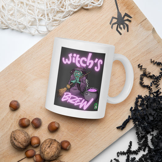 Wizard Prints mug with witch graphic and 'Witch's Brew' text on a wooden board with nuts and spider decorations.