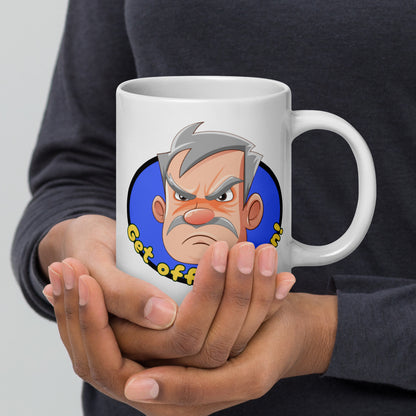 Person holding a white Wizard Prints grumpy old man mug with a cartoon old man graphic and 'Get off my lawn!' text.