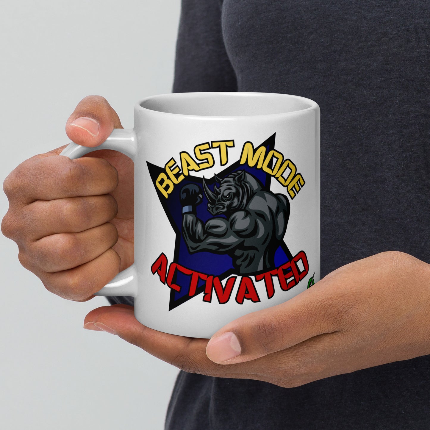 Person holding a Wizard Prints white mug with a graphic design of a rhino and  'Beast Mode Activated' text.