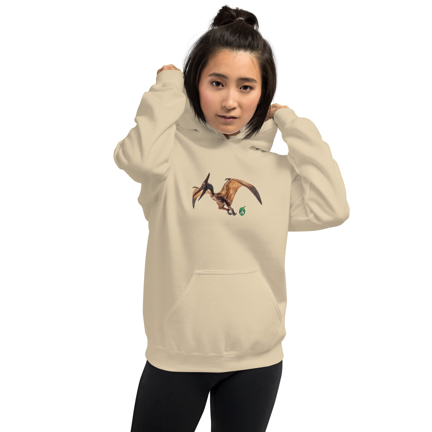 A woman standing wearing a beige hoodie with a printed graphic of a life like pterodactyl dinosaur. Designed by Wizard Prints.