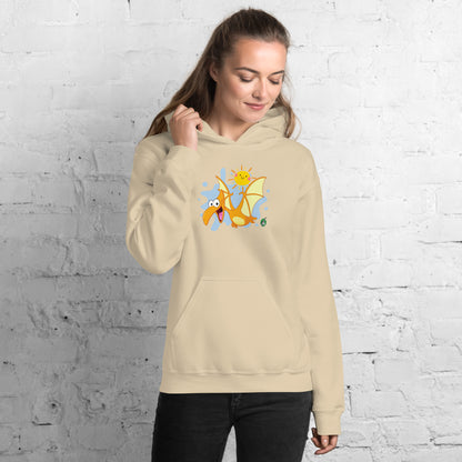 A woman standing wearing a beige hoodie with a printed graphic of a smiling cartoon dinosaur and the sun. Designed by Wizard Prints.