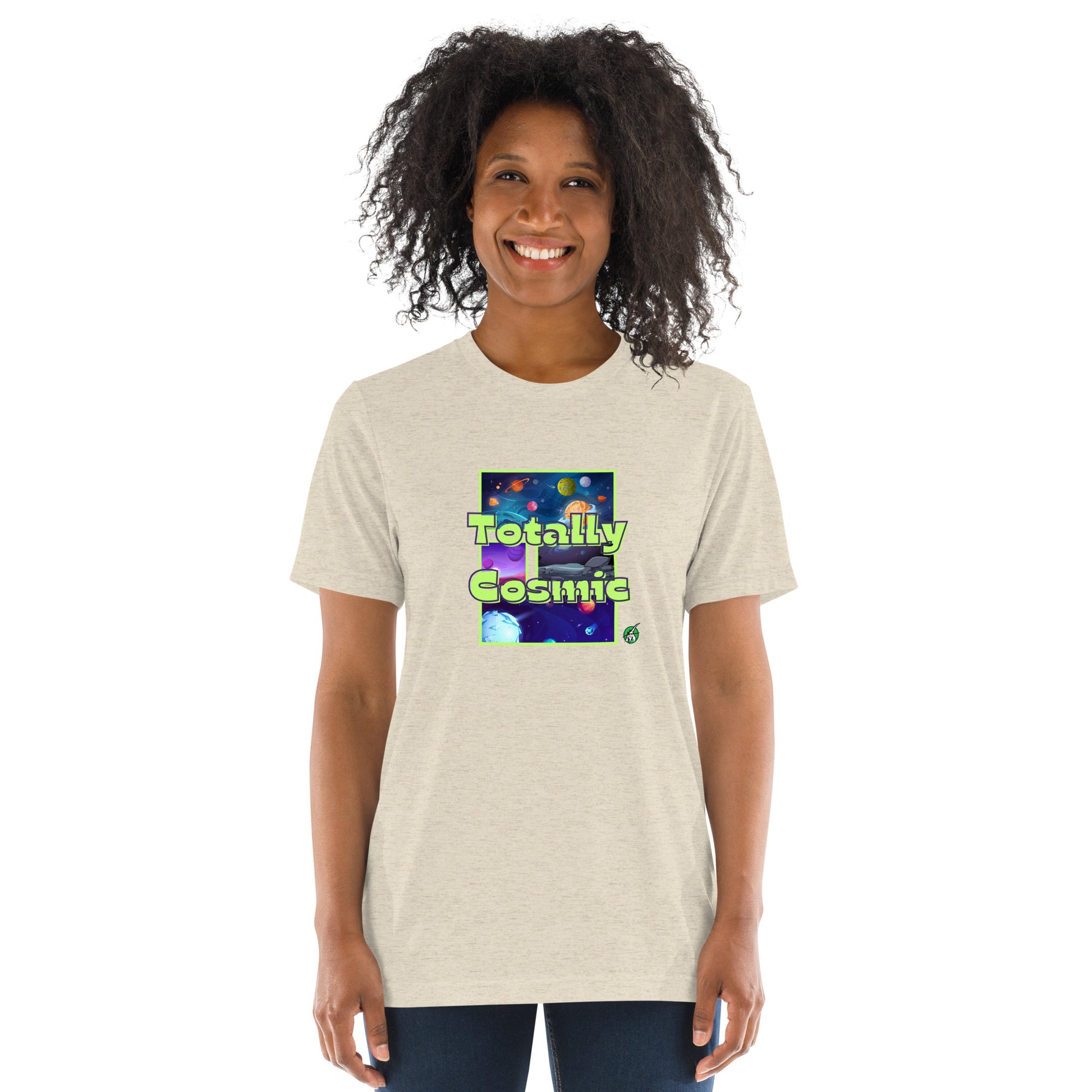 A woman standing wearing a beige t-shirt by Wizard Prints featuring a printed graphic of colorful planets in the background with the words “Totally Cosmic” on top.