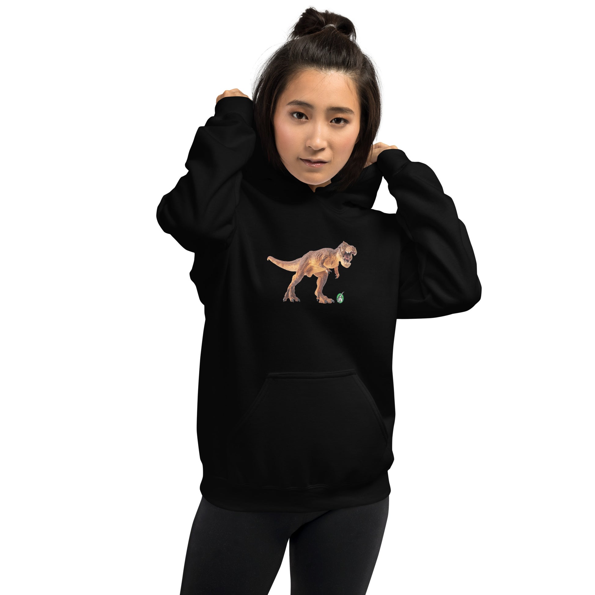 A woman standing wearing a black hoodie with a printed graphic of a life like dinosaur. Designed by Wizard Prints.