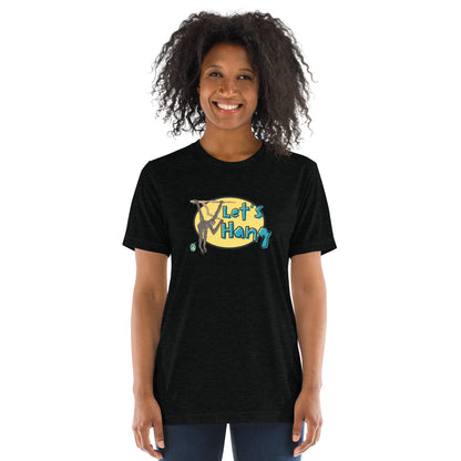 A woman standing wearing a black tee shirt with a printed graphic of a monkey hanging on a branch with the words, Let's Hang. Designed by Wizard Prints