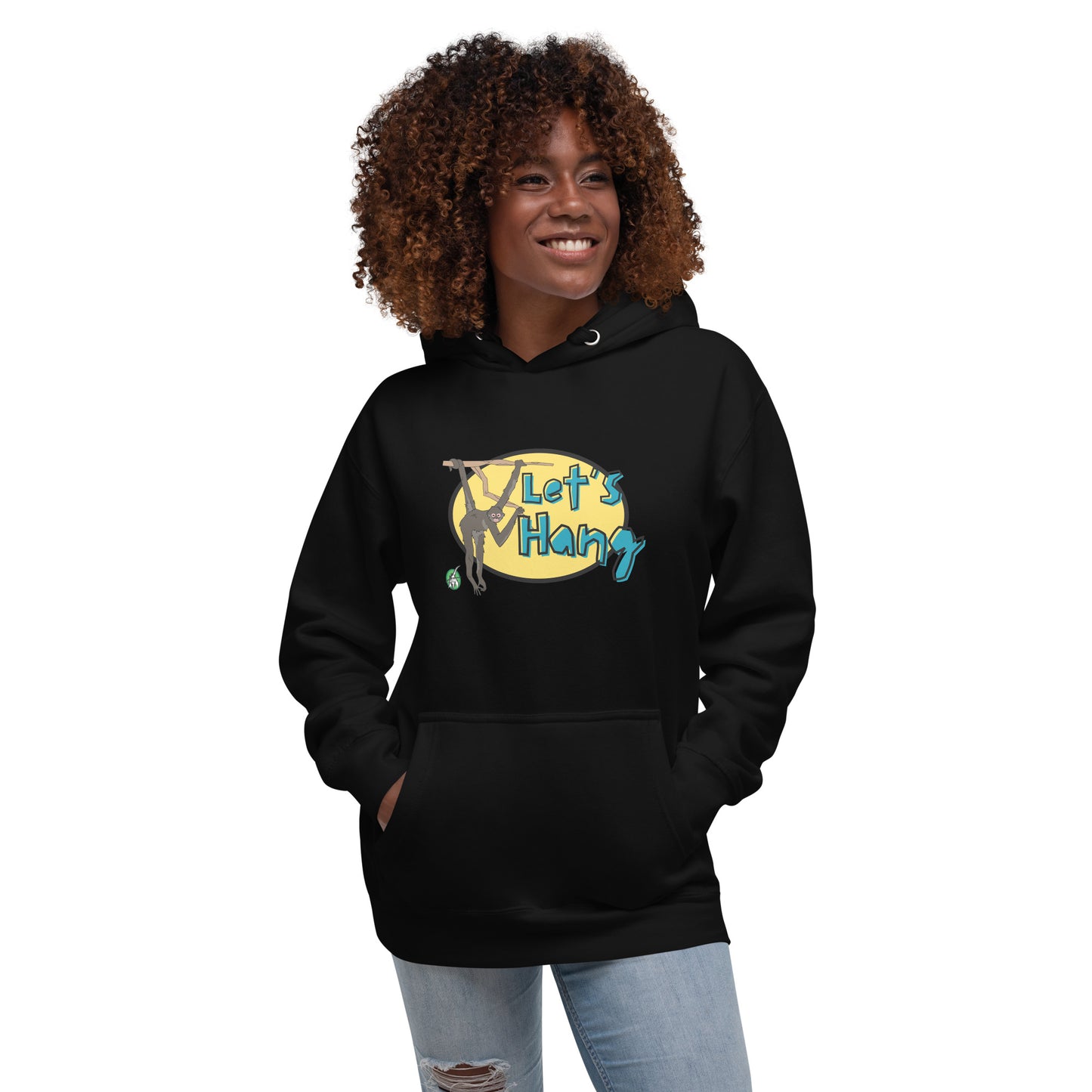 A woman standing wearing black hoodie with a printed graphic of a monkey hanging on a branch with the words, Let's Hang. Designed by Wizard Prints.