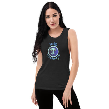 A woman standing wearing a black tank top by Wizard Prints with a printed graphic of a blue alien and the words, No Sign of Intelligent Life.