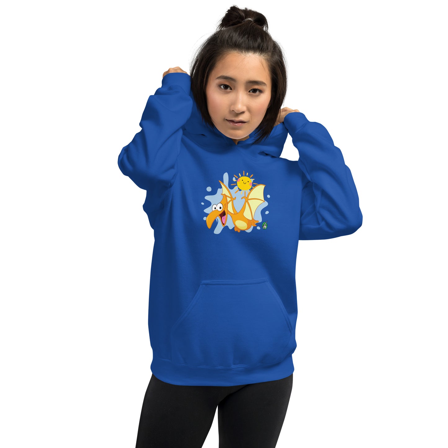 A woman standing wearing a blue hoodie with a printed graphic of a smiling cartoon dinosaur and the sun. Designed by Wizard Prints.