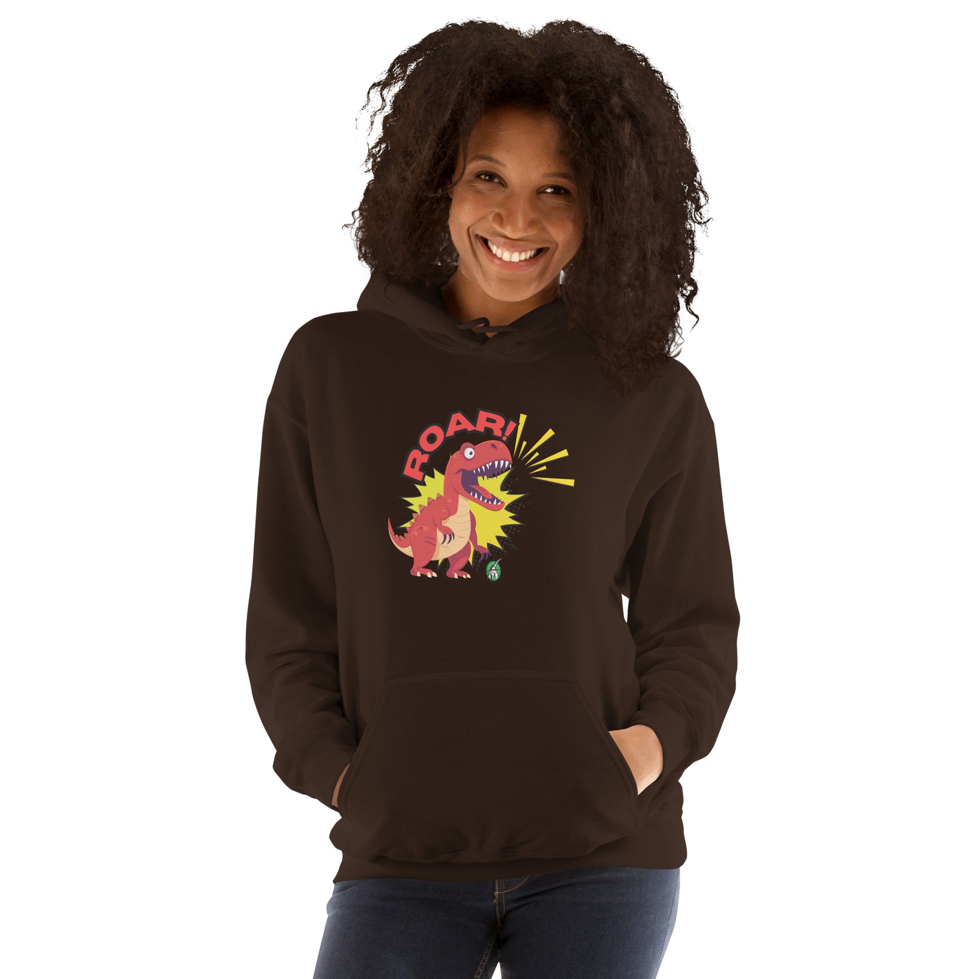 A woman standing wearing a brown hoodie with a printed graphic of a red roaring cartoon dinosaur and the word Roar! Designed by Wizard Prints