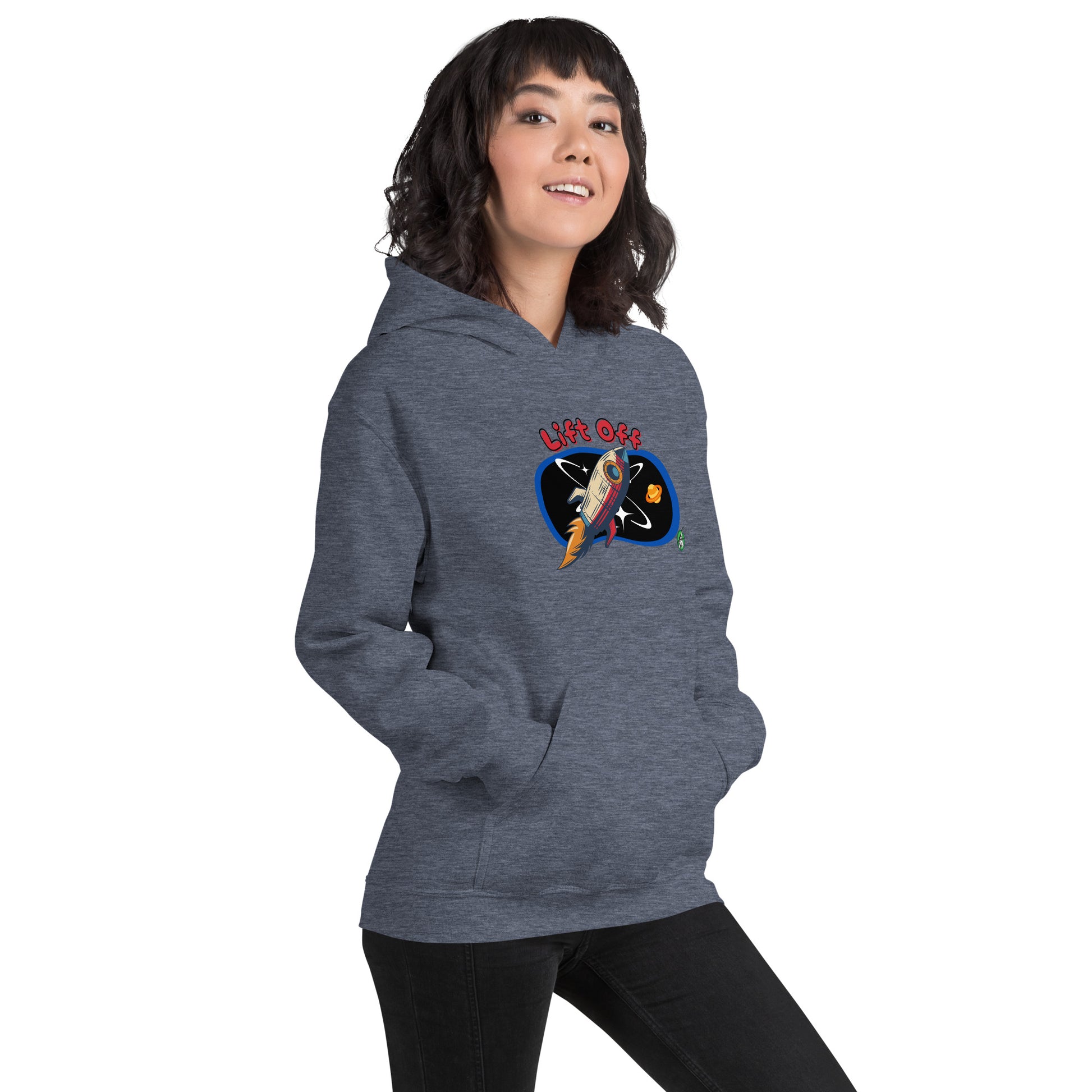 A woman standing wearing a dark grey hoodie with a printed graphic of a rocket and the words, Lift Off. Designed by Wizard Prints.