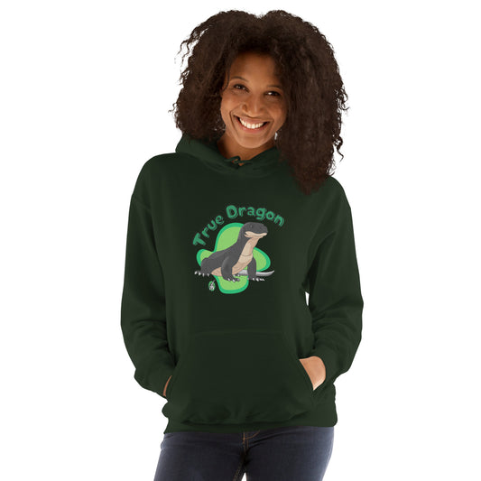 A woman standing wearing a forest green hoodie with a printed graphic of a komodo dragon and the words, True Dragon. Designed by Wizard Prints.