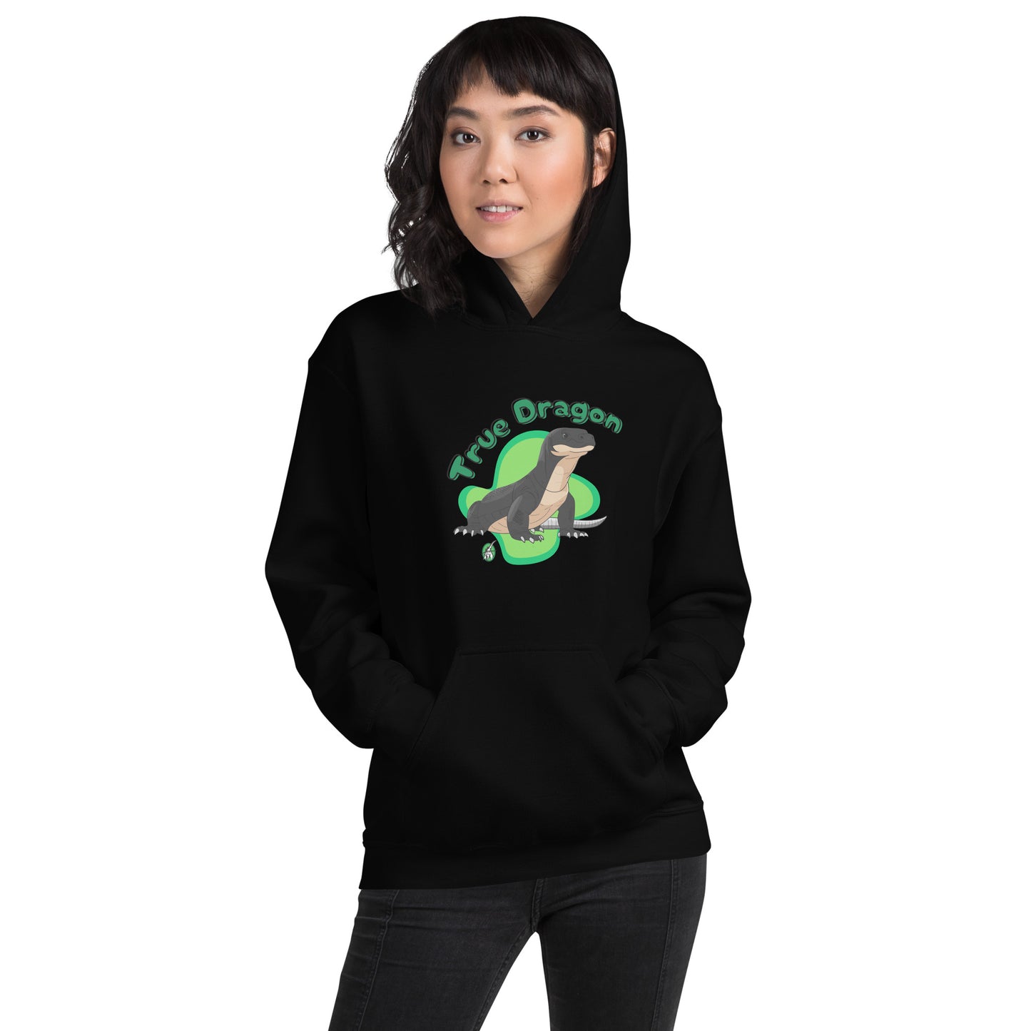 A woman standing wearing a black hoodie with a printed graphic of a komodo dragon and the words, True Dragon. Designed by Wizard Prints.