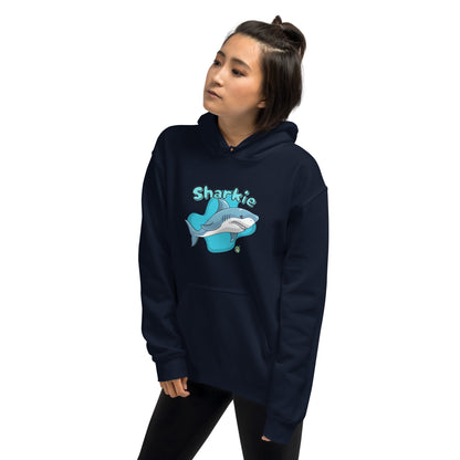 A woman standing wearing a navy blue hoodie with a printed graphic of a cartoon shark and the word, Sharkie. Designed by Wizard Prints.