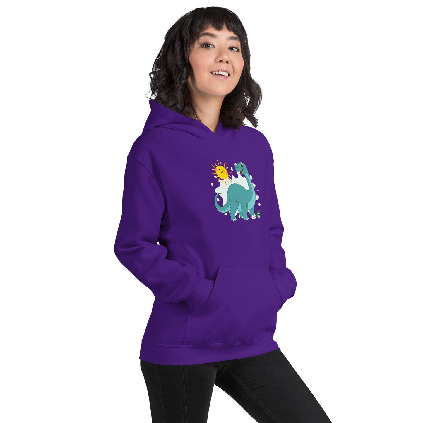 A woman standing wearing a purple hoodie with a printed graphic of a smiling cartoon dinosaur and the sun. Designed by Wizard Prints.