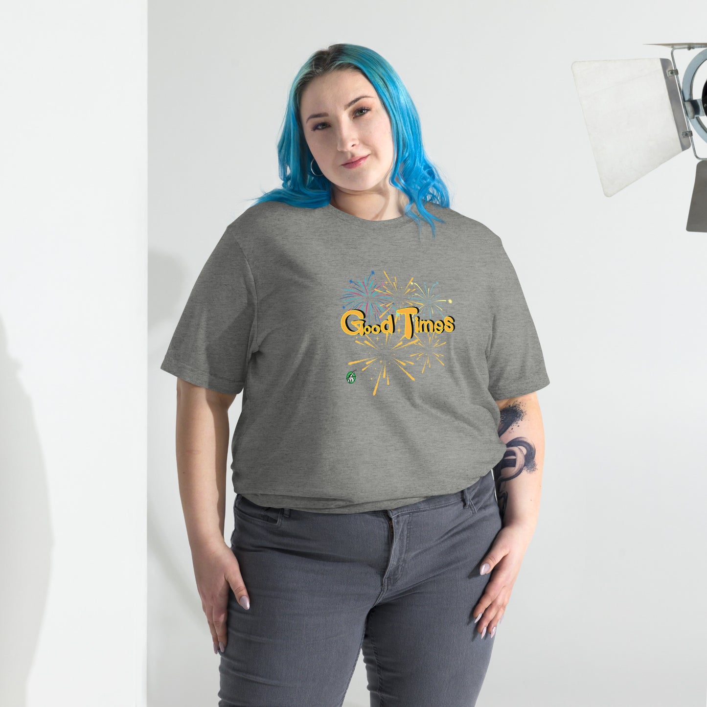 A woman standing wearing a grey tee shirt with a printed graphic of fireworks with the words, Good Times. Designed by Wizard Prints