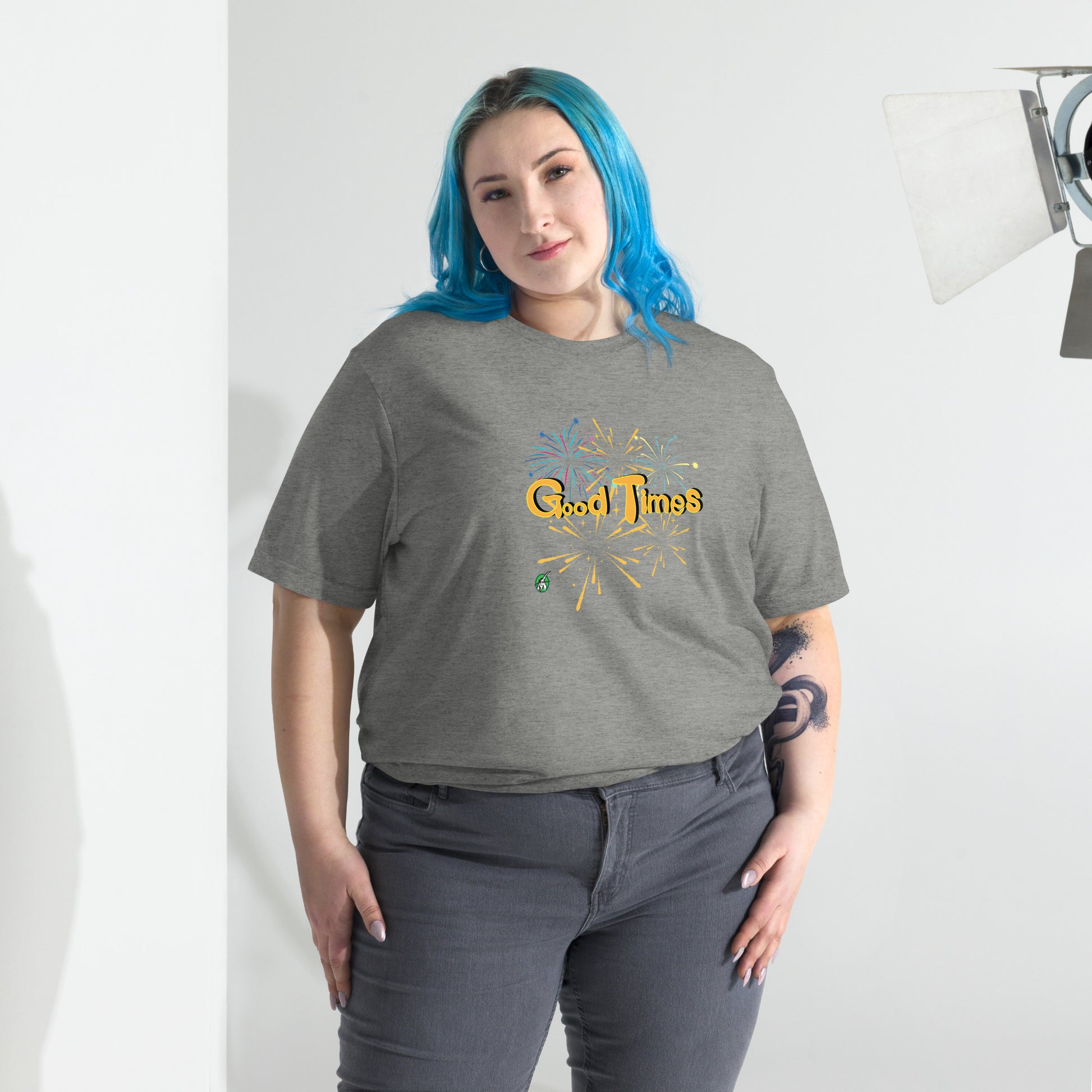 A woman standing wearing a grey tee shirt with a printed graphic of fireworks with the words, Good Times. Designed by Wizard Prints