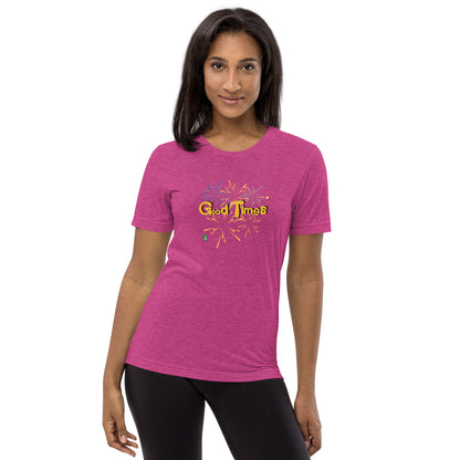 A woman standing wearing a pink tee shirt with a printed graphic of fireworks with the words, Good Times. Designed by Wizard Prints