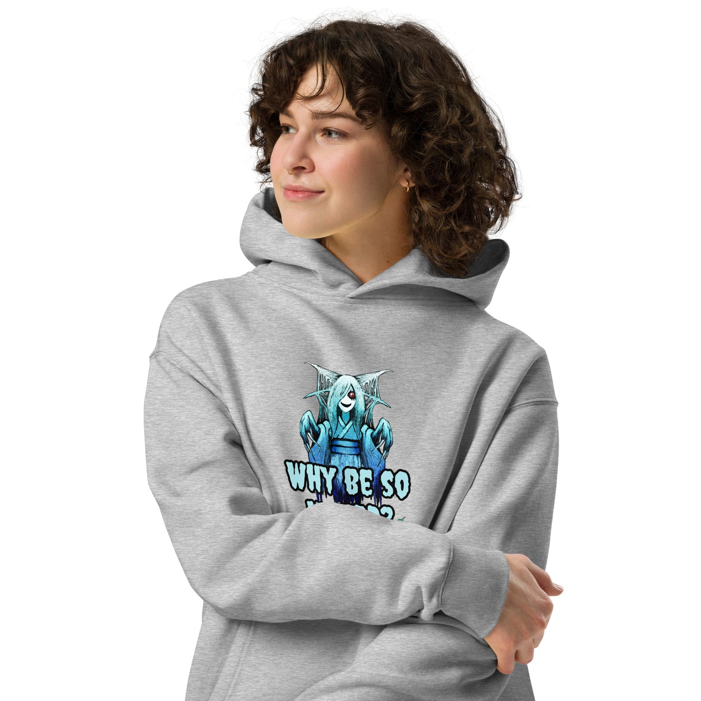 A woman standing wearing a grey hoodie by Wizard Prints featuring a printed graphic of a blue ghost girl with the words, Why Be So Weird?.