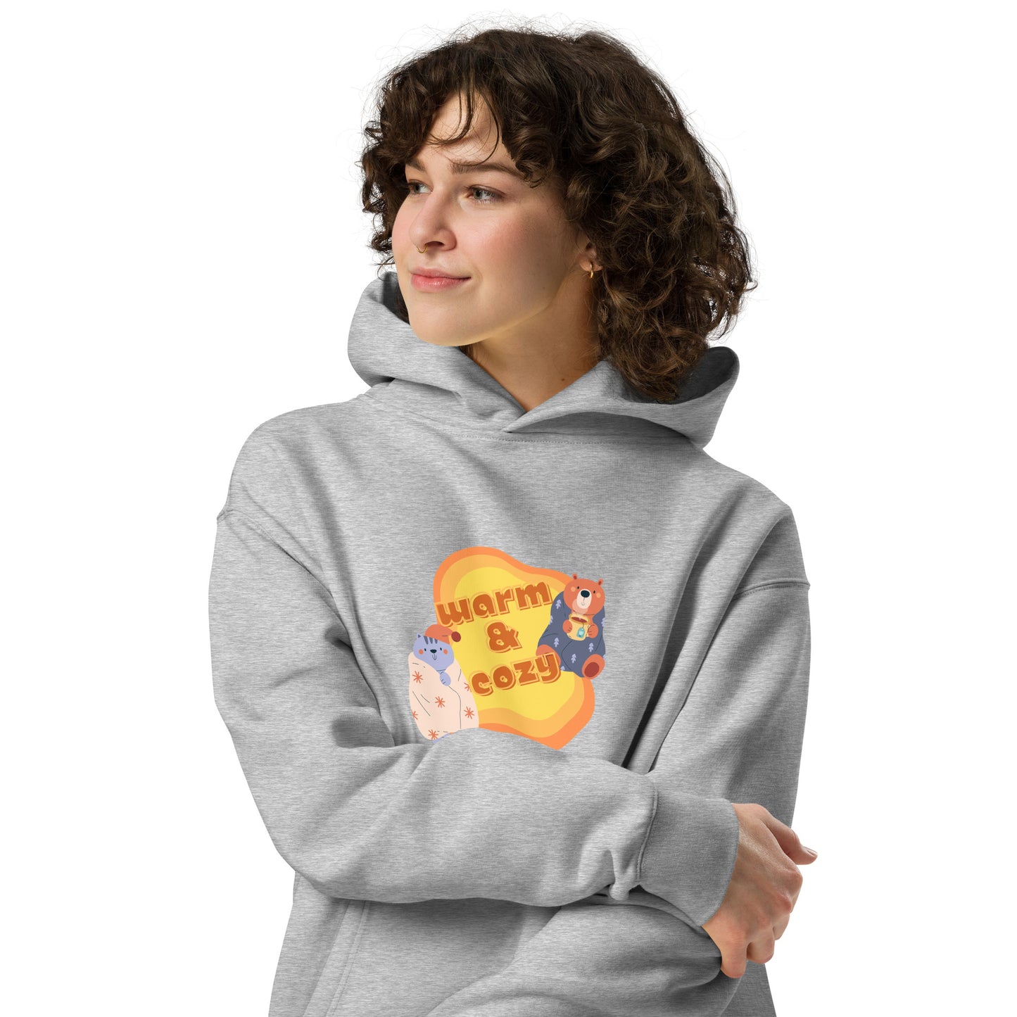 Women's grey hoodie by Wizard Prints featuring a printed graphic of a cartoon cat and bear wrapped in blankets and the words, Warm & Cozy. 