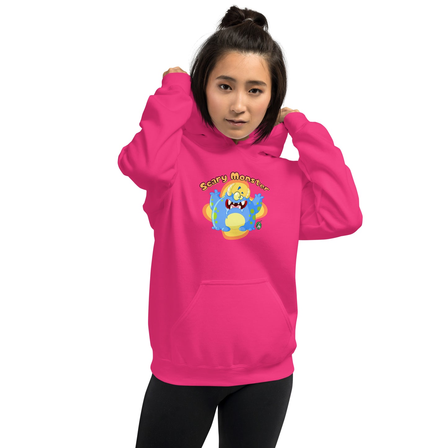 A woman standing wearing a heliconia pink hoodie with a printed graphic of a cartoon monster and the words, Scary Monster. Designed by Wizard Prints.
