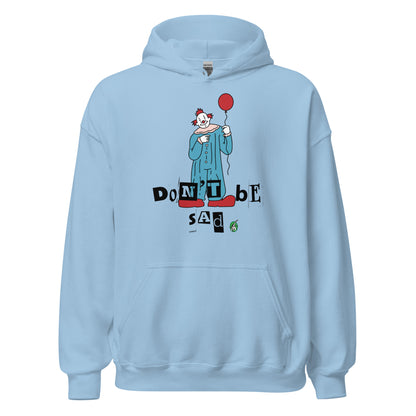 Women's baby blue hoodie with a printed graphic of a clown holding a balloon with the words, 'Don't Be Sad'. Designed by Wizard Prints.