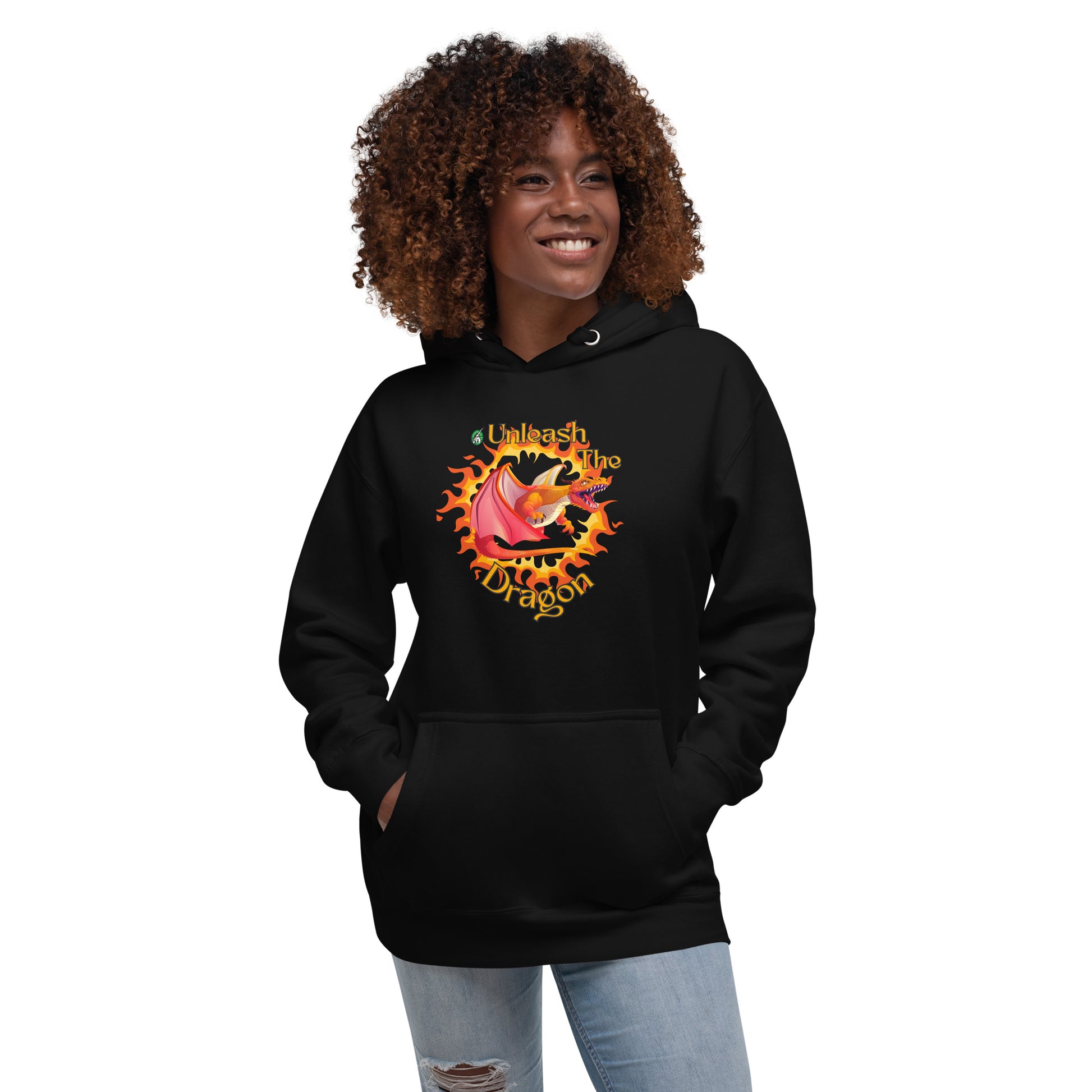 A woman standing wearing a black hoodie with a printed graphic of a fire-breathing dragon with the words, 'Unleash the Dragon'. Designed by Wizard Prints.