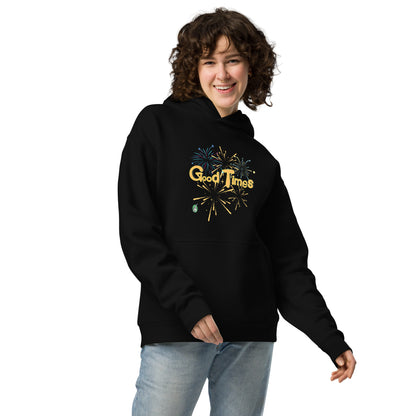 A woman standing wearing a black hoodie by Wizard Prints featuring a printed graphic of fireworks with the words, 'Good Times'.