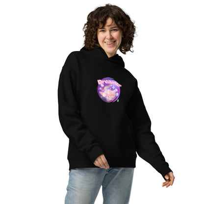 A woman standing wearing a black hoodie by Wizard Prints featuring a printed graphic of a galaxy background and the word Dreamer on top.