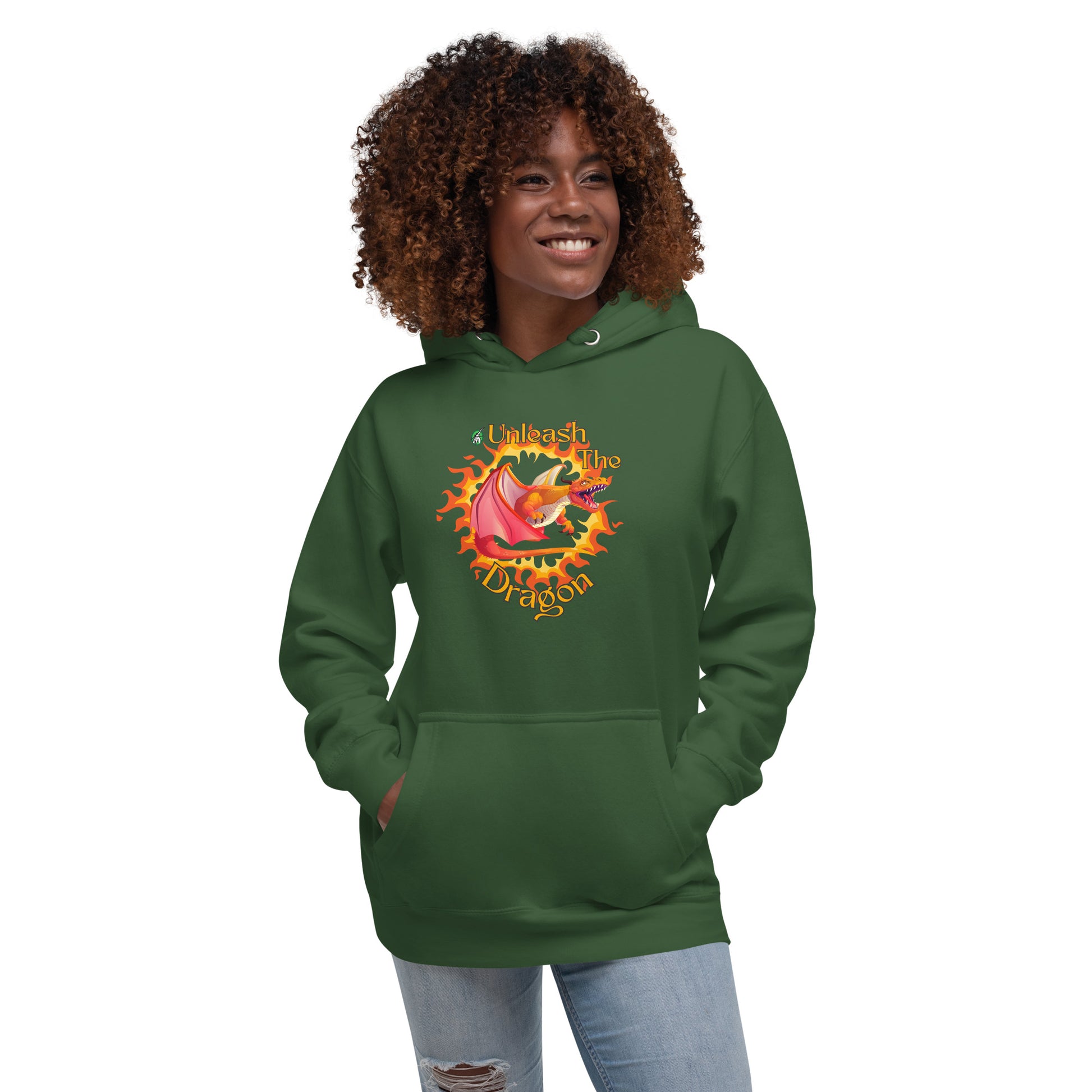 A woman standing wearing a forest green hoodie with a printed graphic of a fire-breathing dragon with the words, 'Unleash the Dragon'. Designed by Wizard Prints.