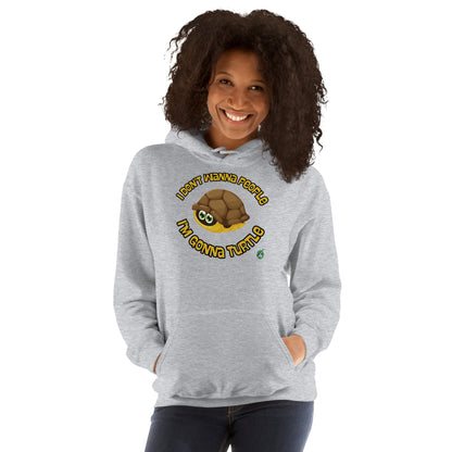 A woman standing wearing a grey hoodie with a printed graphic of a turtle with the words, 'I Don't Wanna People, I'm Gonna Turtle'. Designed by Wizard Prints.