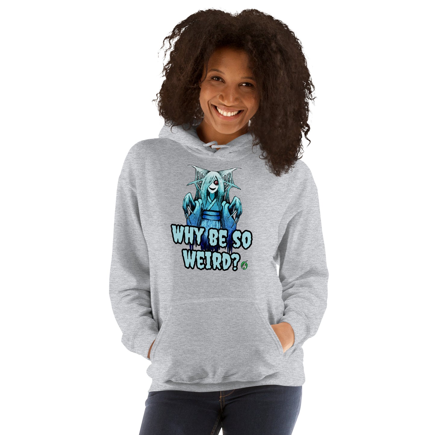 A woman standing and wearing a grey hoodie with a printed graphic of a blue ghost girl with the words, 'Why Be So Weird?'. Designed by Wizard Prints.