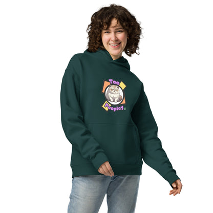 A woman standing wearing a pine green hoodie by Wizard Prints featuring a printed graphic of a grumpy cat with the words, Too Peopley.