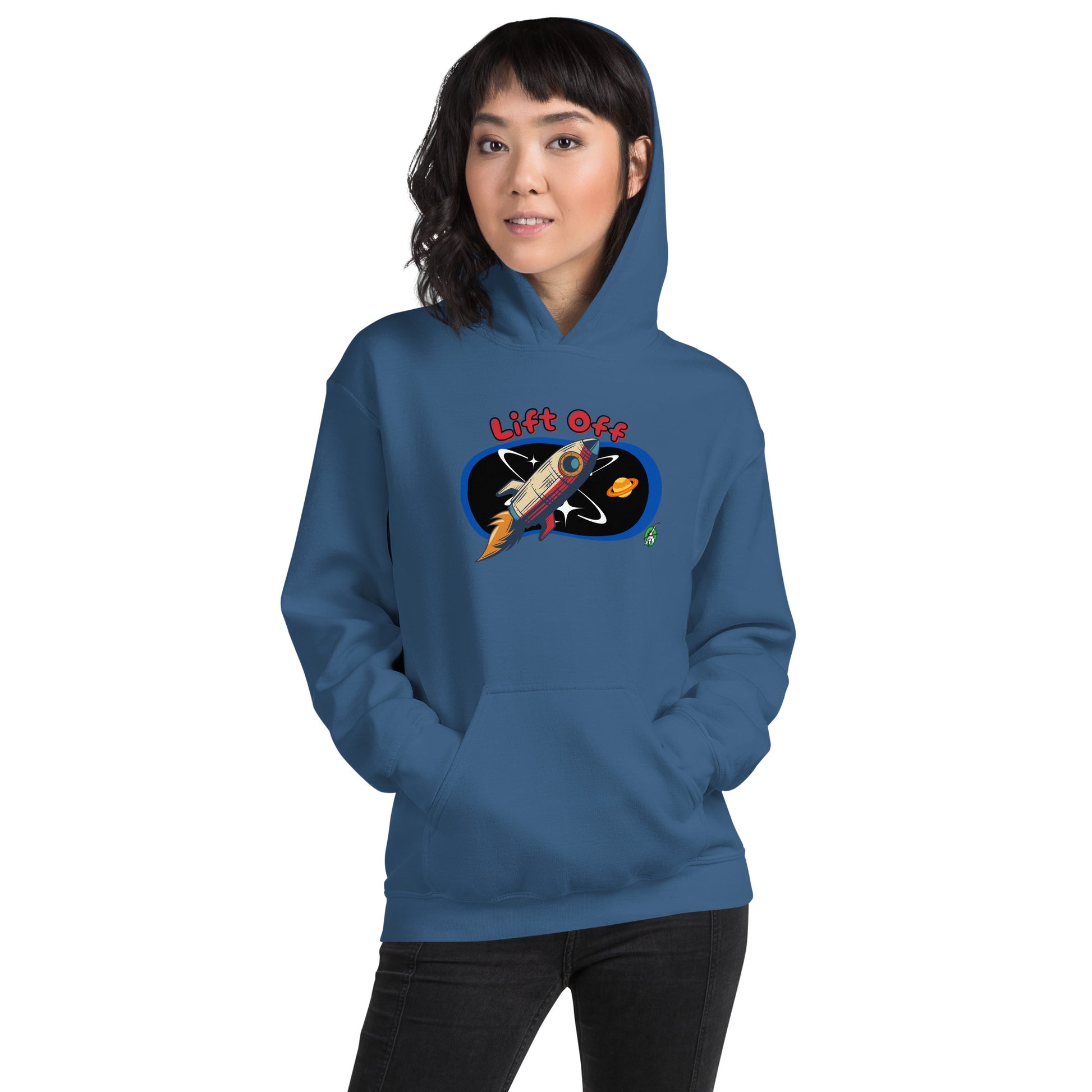 A woman standing wearing an indigo hoodie with a printed graphic of a rocket and the words, Lift Off. Designed by Wizard Prints.
