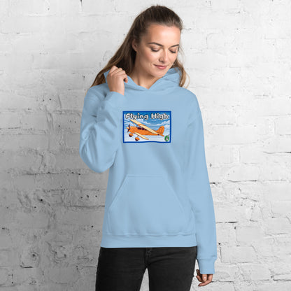 A woman standing wearing a light blue hoodie with the printed graphic of a vintage airplane and the words, Flying High, by Wizard Prints.