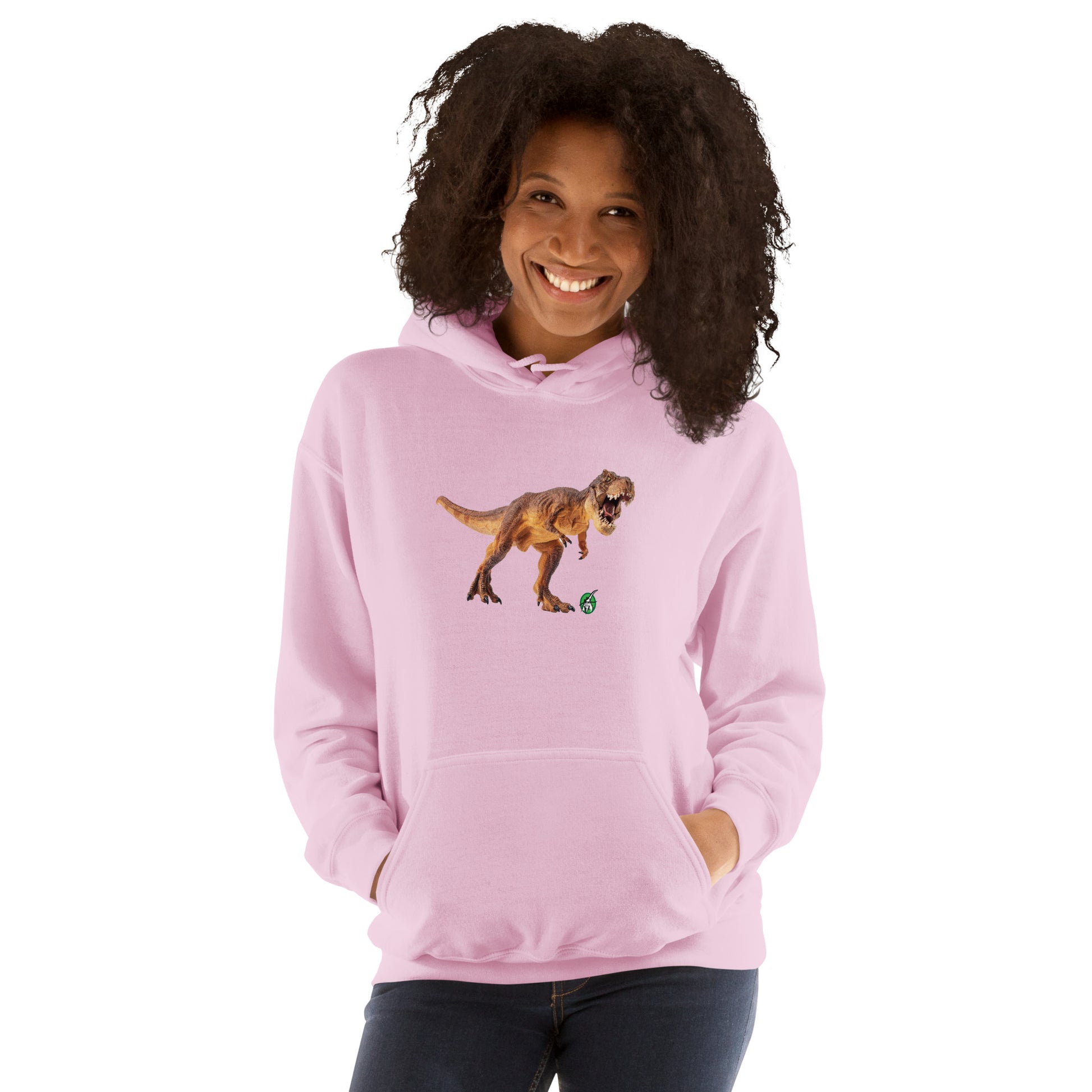 A woman standing wearing a light pink hoodie with a printed graphic of a life like dinosaur. Designed by Wizard Prints.