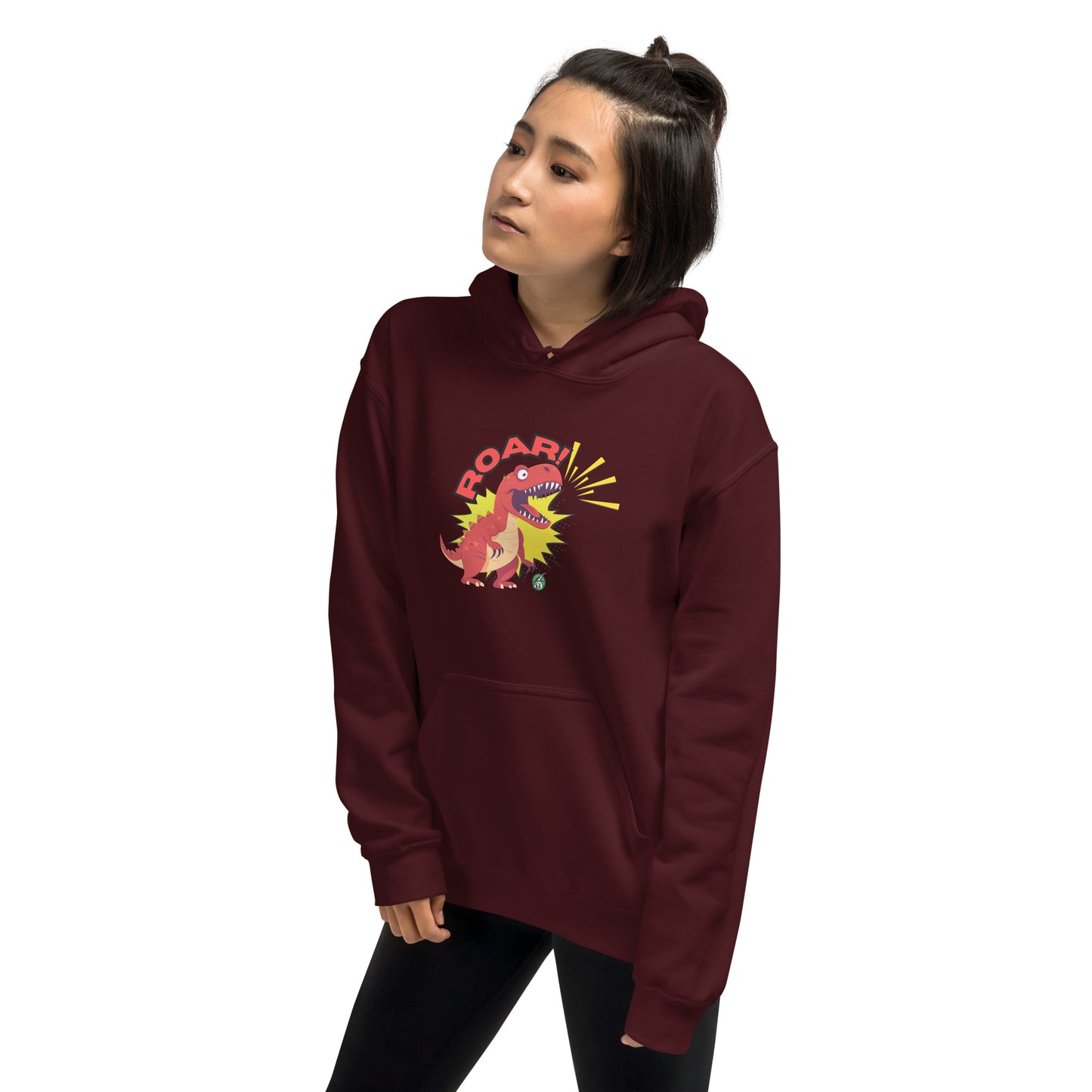 A man standing wearing a maroon hoodie with a printed graphic of a red roaring cartoon dinosaur and the word Roar! Designed by Wizard Prints