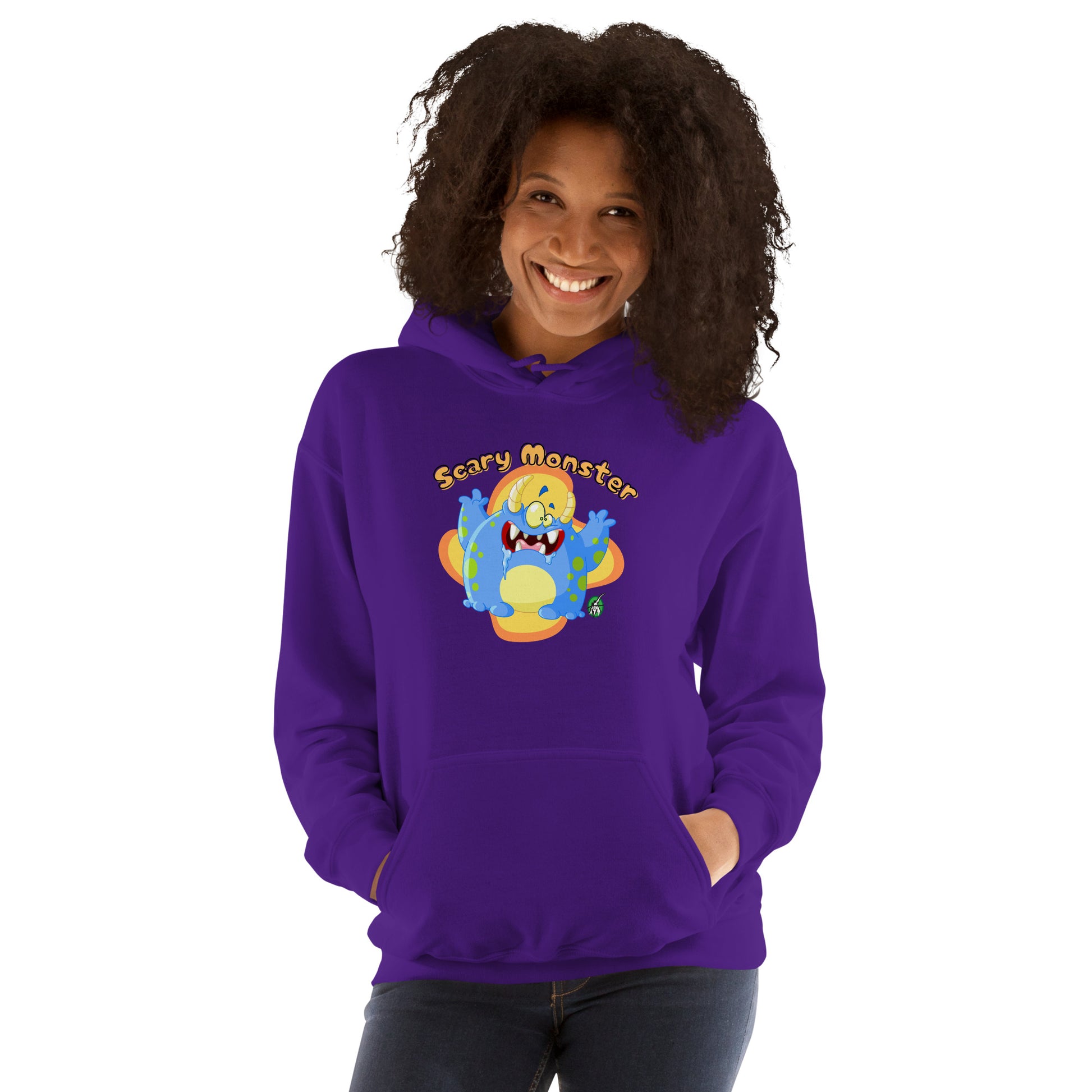 A woman standing wearing a purple hoodie with a printed graphic of a cartoon monster and the words, Scary Monster. Designed by Wizard Prints.