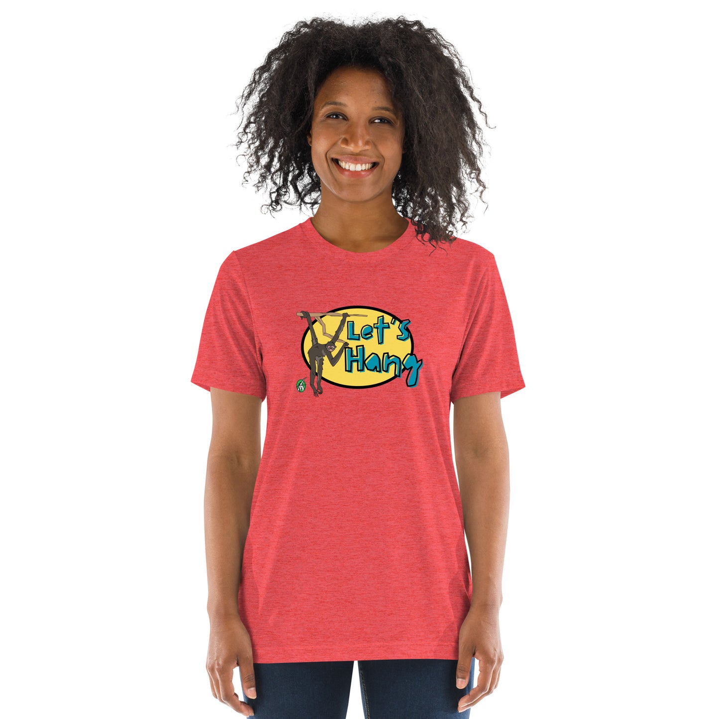 A woman standing wearing a red tee shirt with a printed graphic of a monkey hanging on a branch with the words, Let's Hang. Designed by Wizard Prints