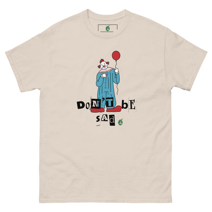Women's beige T-Shirt with a printed graphic of a clown holding a balloon with the words, "Don't be sad". Designed by Wizard Prints