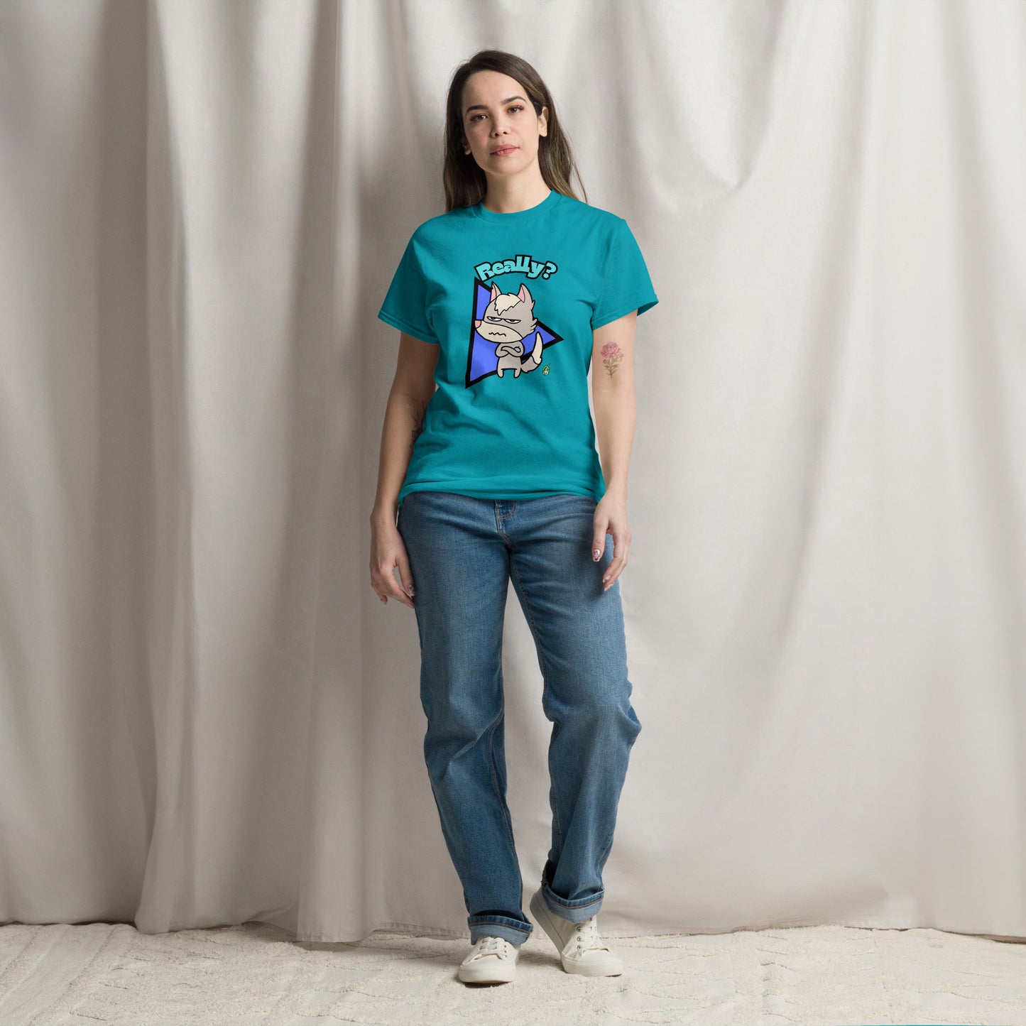 A woman standing wearing a tropical blue t-shirt with a printed graphic of a grumpy fox with the word, 'Really?'. Designed by Wizard Prints.