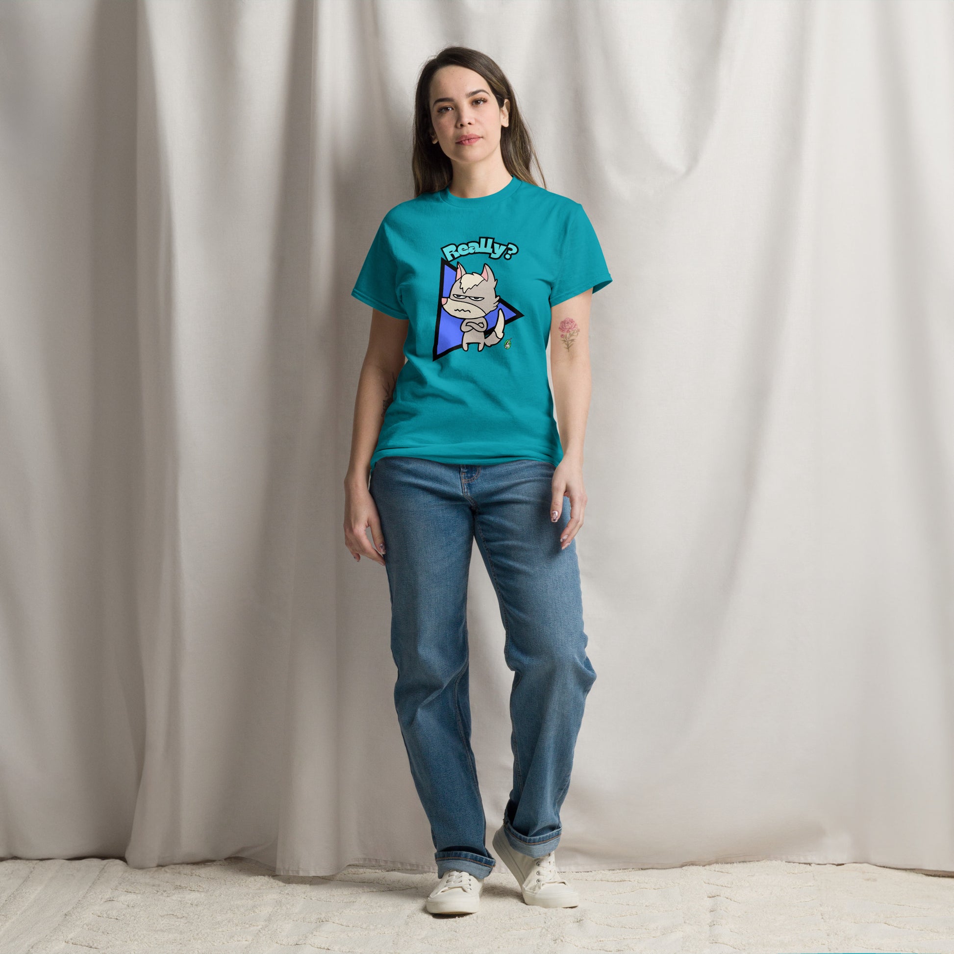 A woman standing wearing a tropical blue t-shirt with a printed graphic of a grumpy fox with the word, 'Really?'. Designed by Wizard Prints.