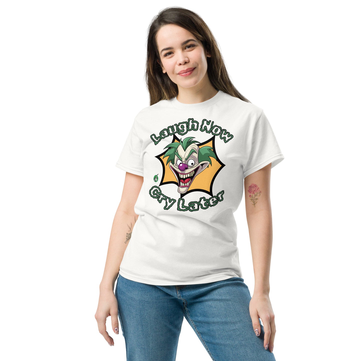 A woman standing wearing a white t-shirt with a printed graphic of a clown with the words, 'Laugh Now, Cry Later'. Designed by Wizard Prints.
