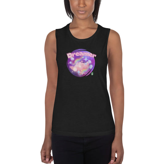 A woman standing wearing a black tank top by Wizard Prints with a printed graphic of a galaxy background and the word Dreamer on top.