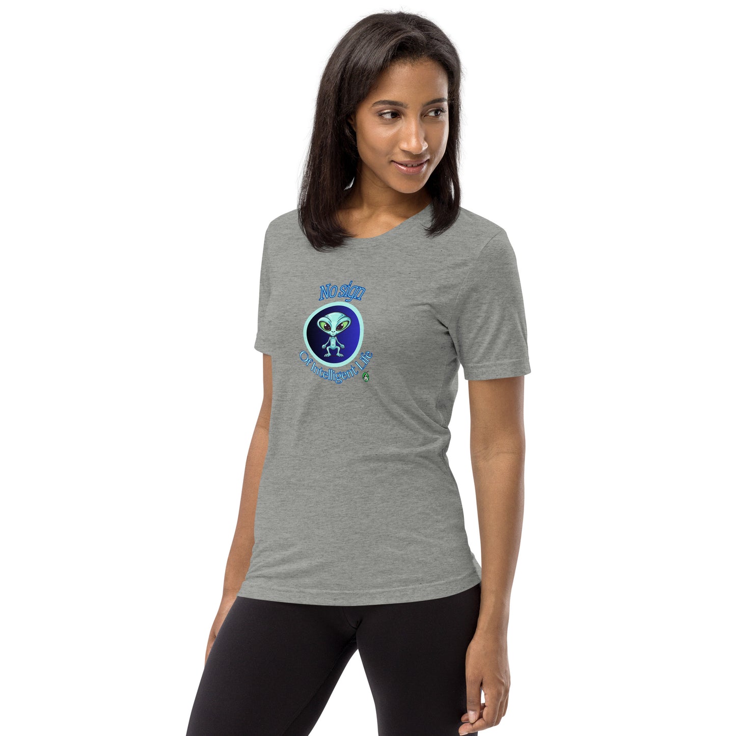 A woman standing wearing a grey tee shirt with a printed graphic of a blue alien and the words No Sign of Intelligent Life. Designed by Wizard Prints