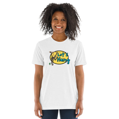 A woman standing wearing a white tee shirt with a printed graphic of a monkey hanging on a branch with the words, Let's Hang. Designed by Wizard Prints